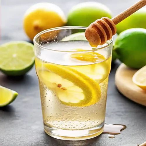 Natural Mounjaro recipe drink in a mason jar with lemon, ginger, cinnamon, and green tea on a wooden table