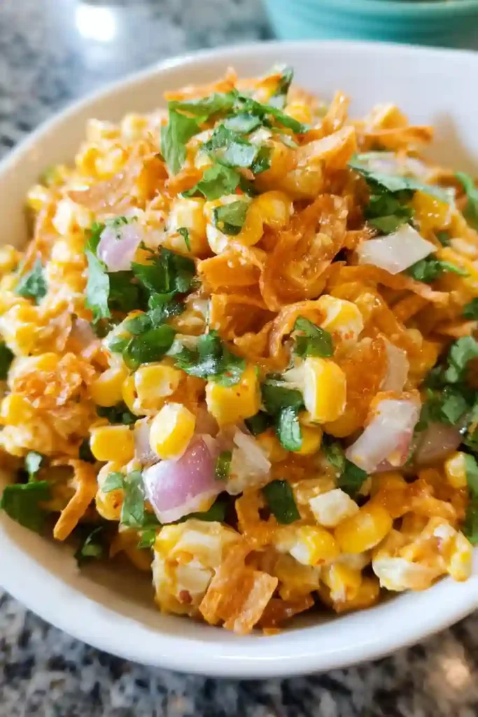 Crushed Chili Cheese Fritos being added to the salad mixture just before serving