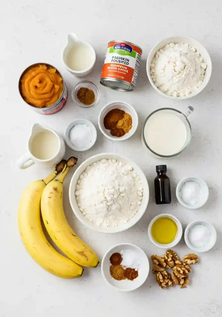 Measured ingredients for pumpkin banana bread on a kitchen counter