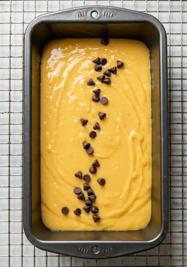 Pumpkin banana bread loaf rising in the oven during baking