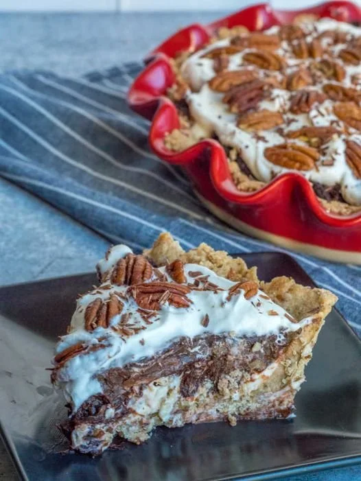 Delicious slice of Arkansas Possum Pie garnished with cream and chocolate.