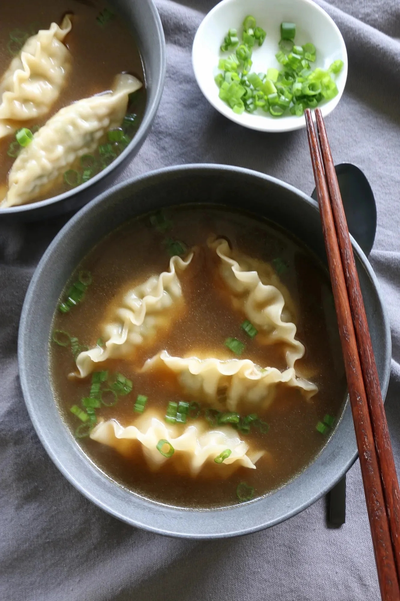 A bowl of easy dumpling soup with fresh ingredients and herbs