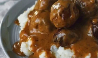Delicious homemade Swedish meatballs served with creamy sauce and mashed potatoes.