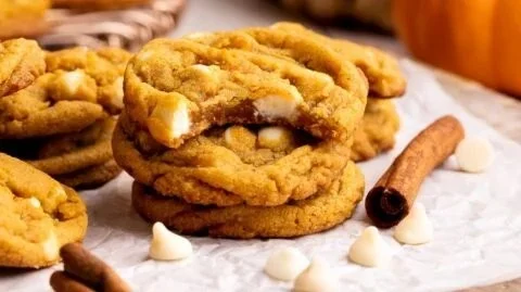 Pumpkin white chocolate chip cookies on a plate with autumn leaves