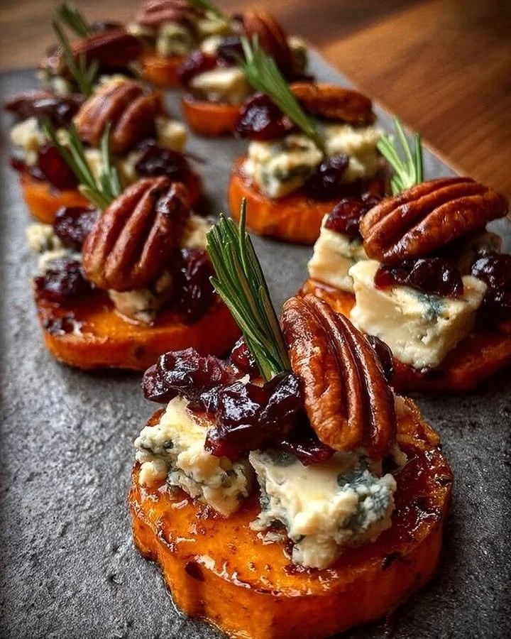 Sweet potato rounds topped with blue cheese, cranberry, and pecans