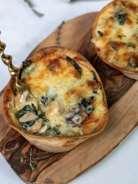 Plate of homemade Tex-Mex chicken tortilla cups topped with fresh ingredients