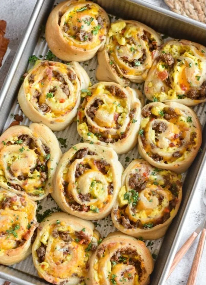 Delicious breakfast rolls served warm with butter and jam