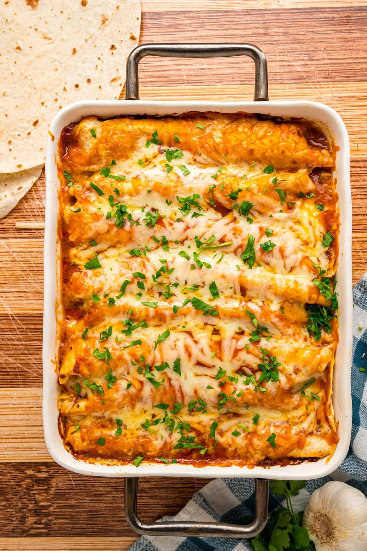 Delicious homemade Chicken Enchiladas topped with melted cheese and fresh salsa.
