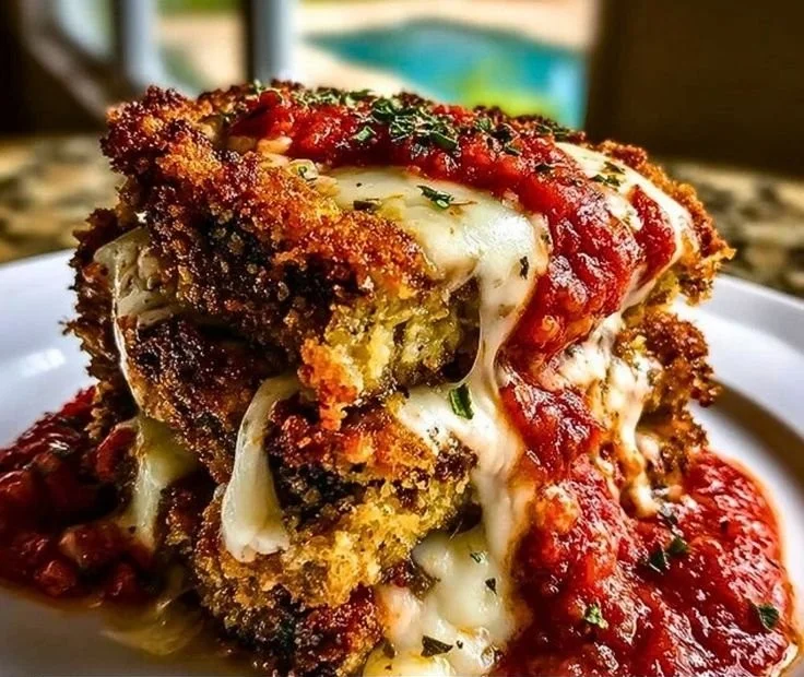 Crispy baked eggplant parmesan topped with cheese and marinara sauce