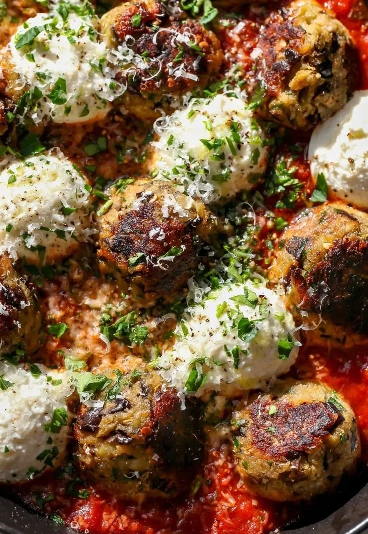 Eggplant Parmesan Meatballs garnished with herbs on a plate