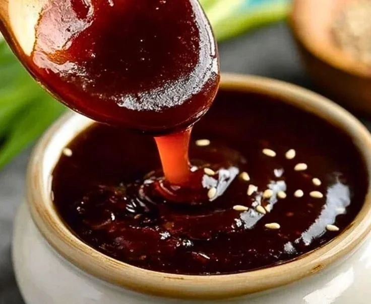 Bowl of homemade hoisin sauce with ingredients like soy sauce and sesame oil