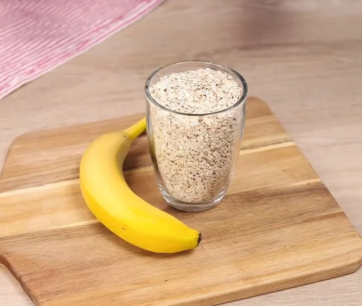 Delicious Oat Cocoa Banana Dessert served in a bowl with a spoon.