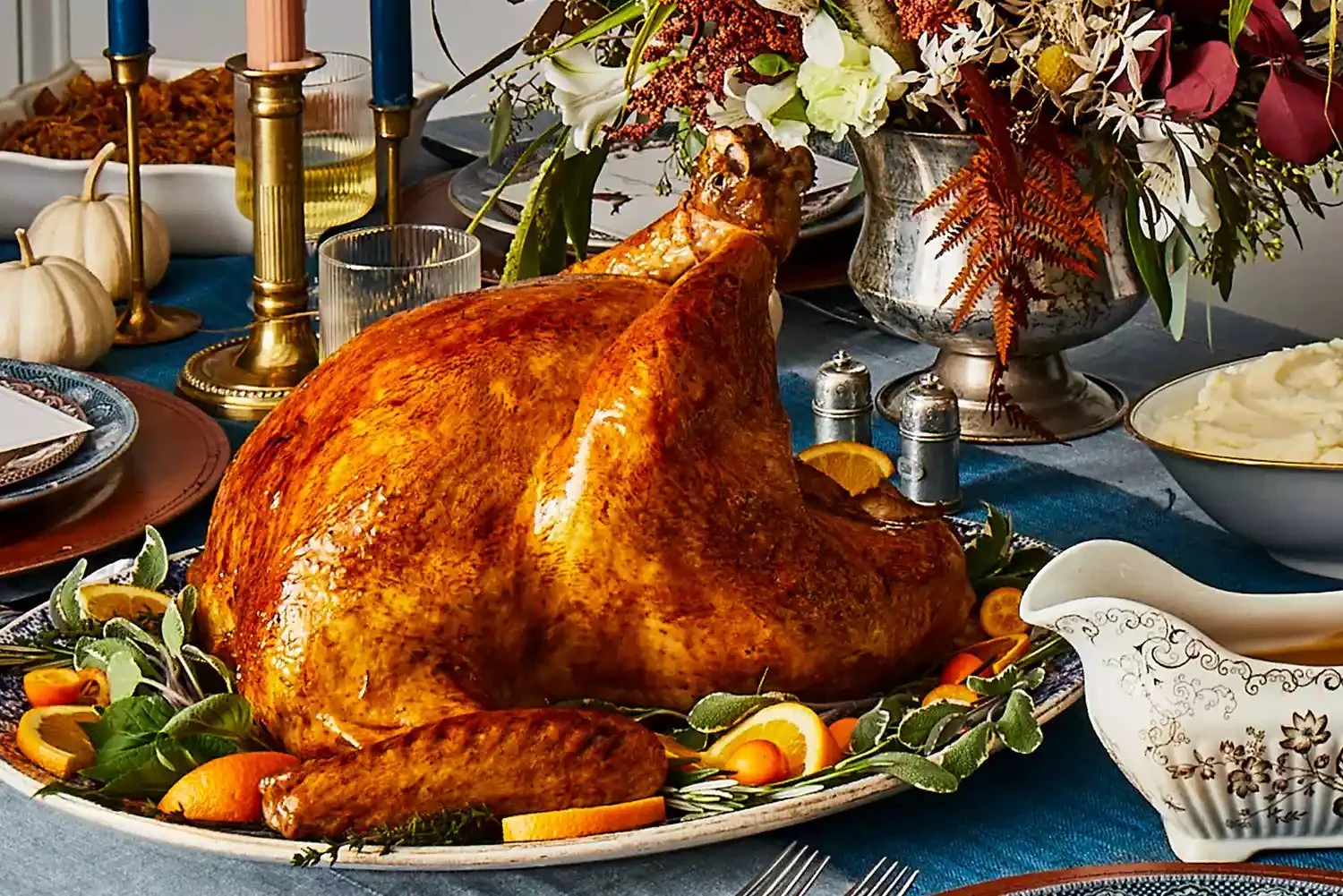 A perfectly cooked turkey on a festive dining table, ready for a holiday meal.
