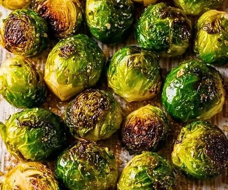 Delicious roasted Brussels sprouts garnished and served on a plate.