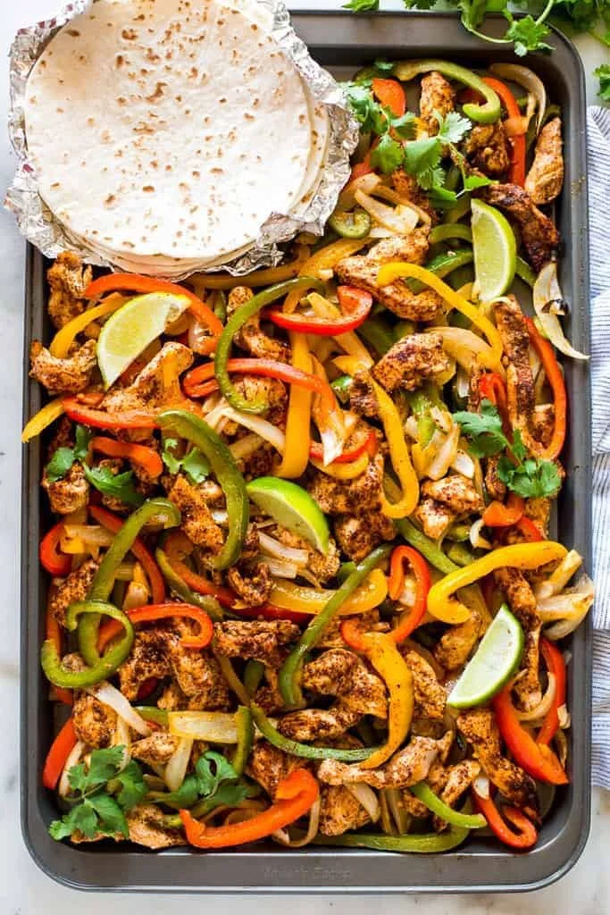 Sheet pan chicken fajitas with colorful peppers and onions ready to serve.