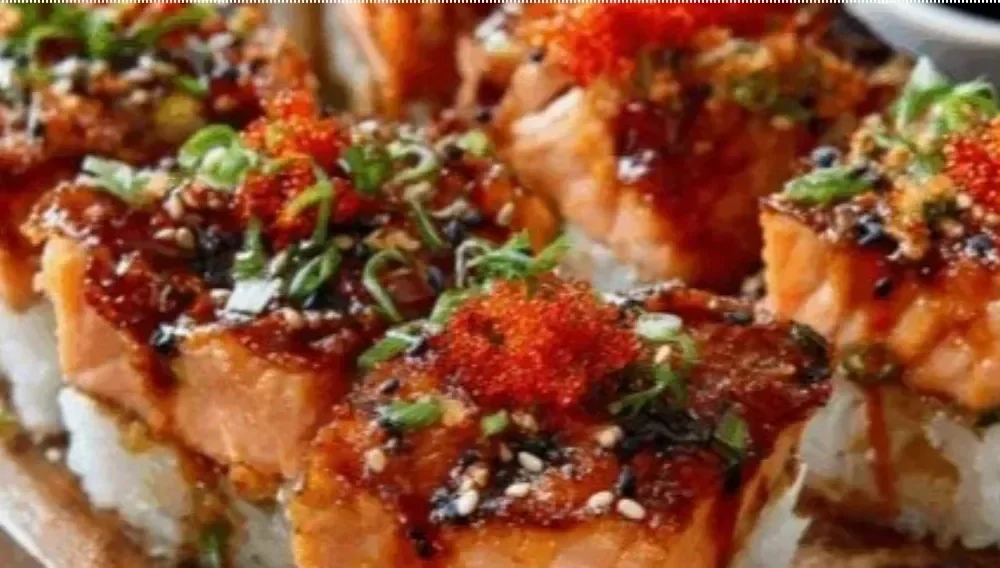 Baked spicy salmon sushi dish topped with creamy sauce and nori